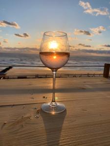 a glass of wine sitting on the beach at LACANAU FRONT DE MER in Lacanau