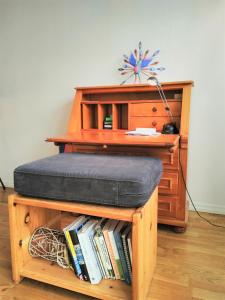 a desk with a pillow and a book shelf with books at Spacious flat with balcony in central & hip area in Gothenburg