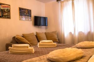 a bedroom with a bed with four pillows on it at Il Villino in Lucca