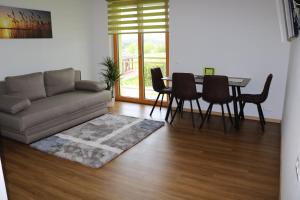 a living room with a couch and a table and chairs at Stadl-Ferienwohnung in Sankt Georgen am Längsee