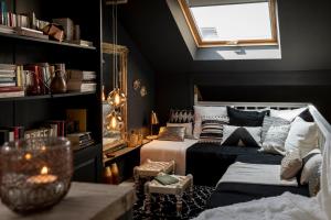 a bedroom with a bed and a couch and a window at Du Coté de chez Jeanne, Suite in Verviers