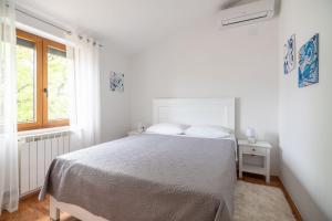 Posteľ alebo postele v izbe v ubytovaní Apartments Norma