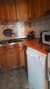 a kitchen with wooden cabinets and a counter top at VILLA MARIA in Vilches +34 photos