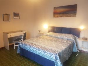 Ένα ή περισσότερα κρεβάτια σε δωμάτιο στο Casa Vacanza Xenìa