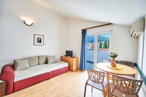 a living room with a couch and a table at Family Apartments Mont Budva in Budva