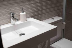 a white sink in a bathroom with a toilet at Tuca del Mont in Benasque