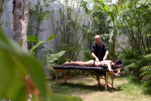 a man and a woman laying on a bed at Villa LaGú Masterpiece Tulum Jungle 5BR Pool & Spa in Tulum
