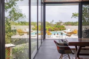 a house with a view of a swimming pool at Villa LaGú Masterpiece Tulum Jungle 5BR Pool & Spa in Tulum