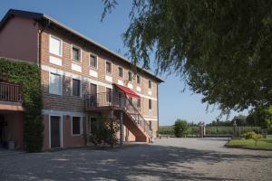 a large brick building with a staircase on the side of it at Chiaro di Luna in San Vito al Tagliamento