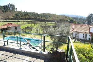 a house with a swimming pool in a yard at Quinta de Vila Verde- Paixão Ancestral, Turismo Rural in Marco de Canaveses