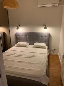 a bedroom with a large bed with two pillows at Floreasca Apartment Bach in Bucharest