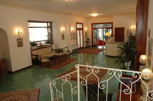 a lobby with a staircase and a living room at Hotel Belvedere in Conca dei Marini
