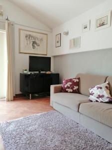 a living room with a couch and a flat screen tv at Apartment Džoni in Split