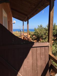 a wooden fence with a view of the ocean at Casa Fabio in Stintino