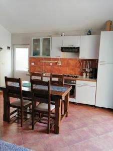 a kitchen with a table and chairs and a refrigerator at Apartment Džoni in Split