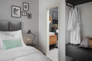 a bedroom with a bed and a sink and a mirror at Olive Hill House - ground floor in Slatine +40 photos