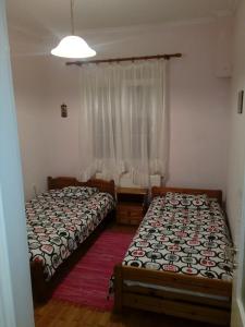 a bedroom with two beds and a window at Big apartment near Olympus mountain in Litochoro