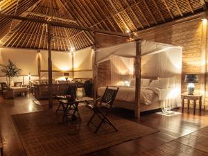 a bedroom with a canopy bed in a room at Villa Shamballa in Ubud