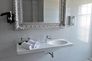 a white bathroom with a sink and a mirror at Hotel La Villa Nice Victor Hugo in Nice