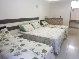 two beds in a room with two beds sidx sidx sidx at Residencial Santa Teresa in Rio de Janeiro