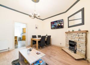 a living room with a table and a fireplace at STAG City Centre apartment in Inverness