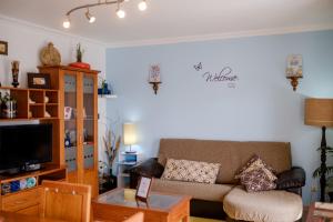 a living room with a couch and a coffee table at Rito´s Paradise in Nazaré