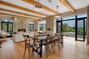 a dining room with a table and chairs and a fireplace at Maunga View in Queenstown