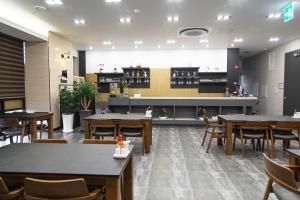 a restaurant with tables and chairs and a counter at Hotel Daoom in Ulsan
