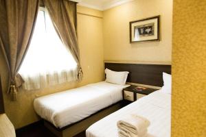 Postel nebo postele na pokoji v ubytování Hotel Valenza
