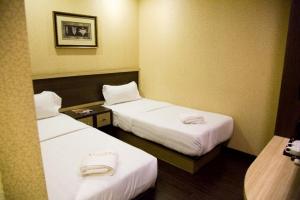 Postel nebo postele na pokoji v ubytování Hotel Valenza