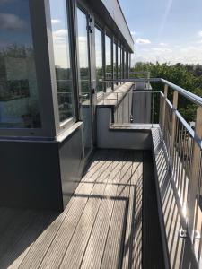 a balcony of a building with a view of the trees at Residentie Kapelhof in Koksijde