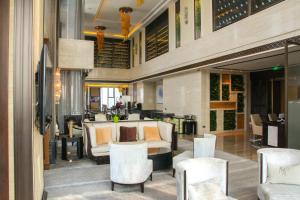 a lobby of a hotel with white furniture and chairs at The Westin Qingdao - Instagrammable in Qingdao