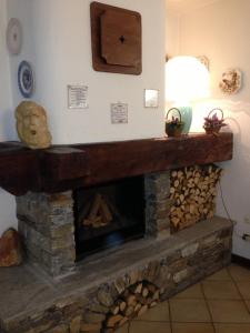 a large stone fireplace with a fireplace mantel at Hotel Triolet in Courmayeur