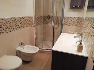 a bathroom with a shower and a toilet and a sink at B&B Nino in Olbia