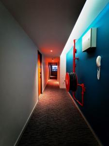 a long hallway with a blue wall and a fire hydrant at Sovotel@Uptown 28 in Petaling Jaya