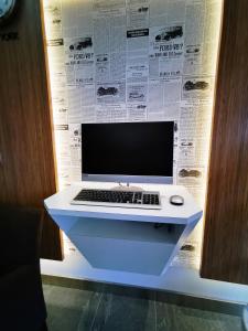 a laptop computer sitting on a white desk with a paper at Sovotel@Uptown 28 in Petaling Jaya +20 photos