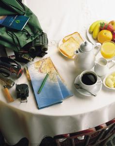 a table with a map and a camera and a cup of coffee at Hotel Gran Rey in Valle Gran Rey