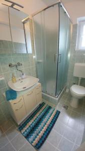 a bathroom with a shower and a sink and a toilet at Apartments Pipi in Pakoštane +58 photos