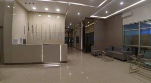 a lobby with chairs and a counter in a building at Patrick s Place in Davao City