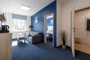 a living room with a couch and a bed at AQUA HOUSE in Sopot
