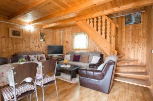 a living room with a couch and a tv in a cabin at Apartment Perić in Rastovača