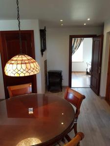 a dining room with a table and chairs and a chandelier at Nojus in Nida