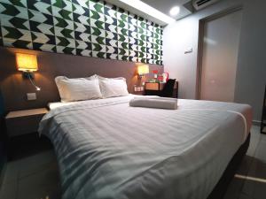 a bedroom with a large bed with a green and white wall at Sovotel@Uptown 28 in Petaling Jaya