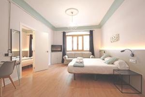 a bedroom with a bed and a living room at Regina Selfcheck-in Smart Rooms in Palma de Mallorca