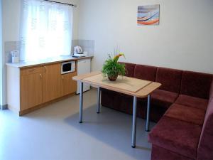 a living room with a couch and a table with a plant on it at Beluga in Šventoji