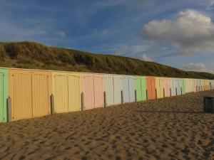 a row of colorful barriers on a beach at Hiltop in Domburg