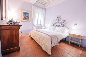 a bedroom with a large bed and a table at Villa La Bianca in Camaiore