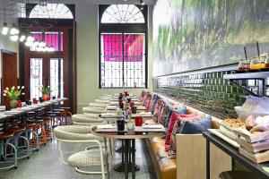 a row of tables and chairs in a restaurant at The Editory House Ribeira Porto Hotel in Porto