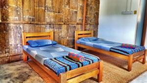 En eller flere senge i et værelse på Borneo Tribal Village (BTV)