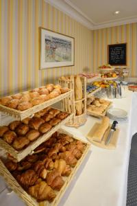 a table with many trays of bread and pastries at Hotel Splendid in Cannes